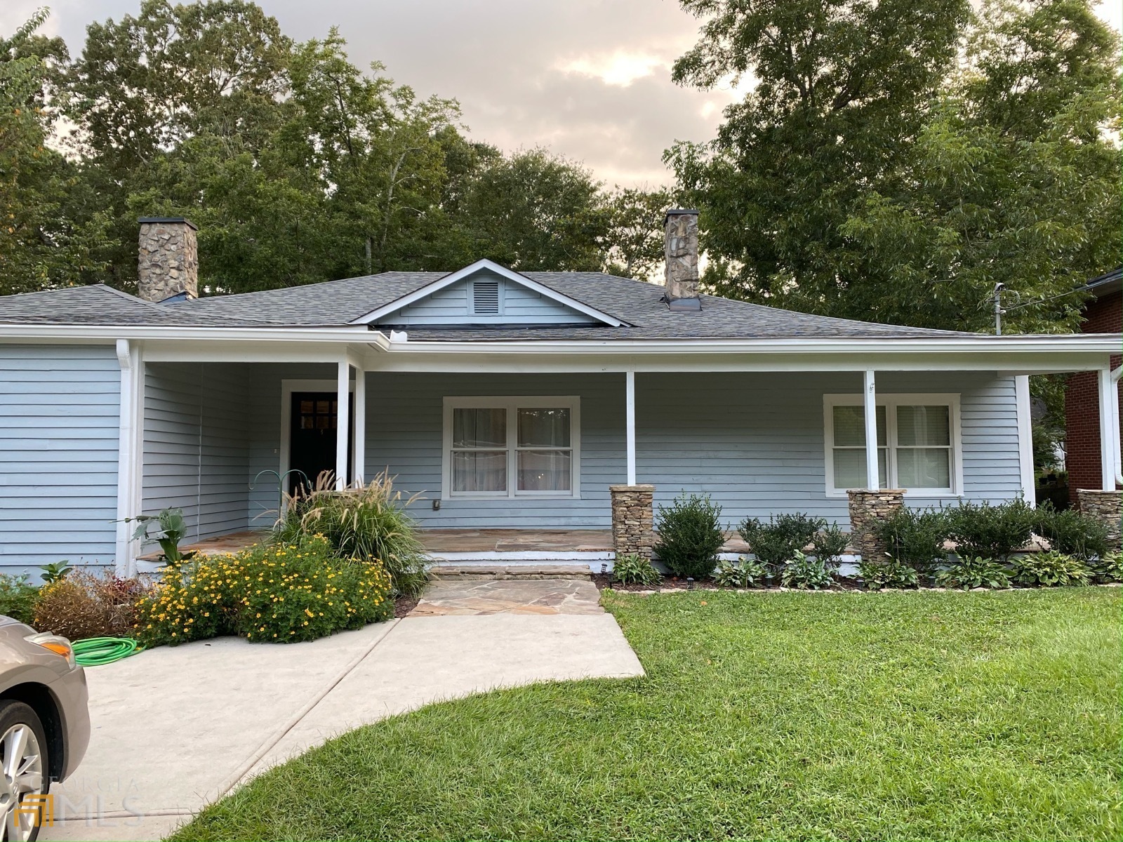 a front view of a house with a yard and porch