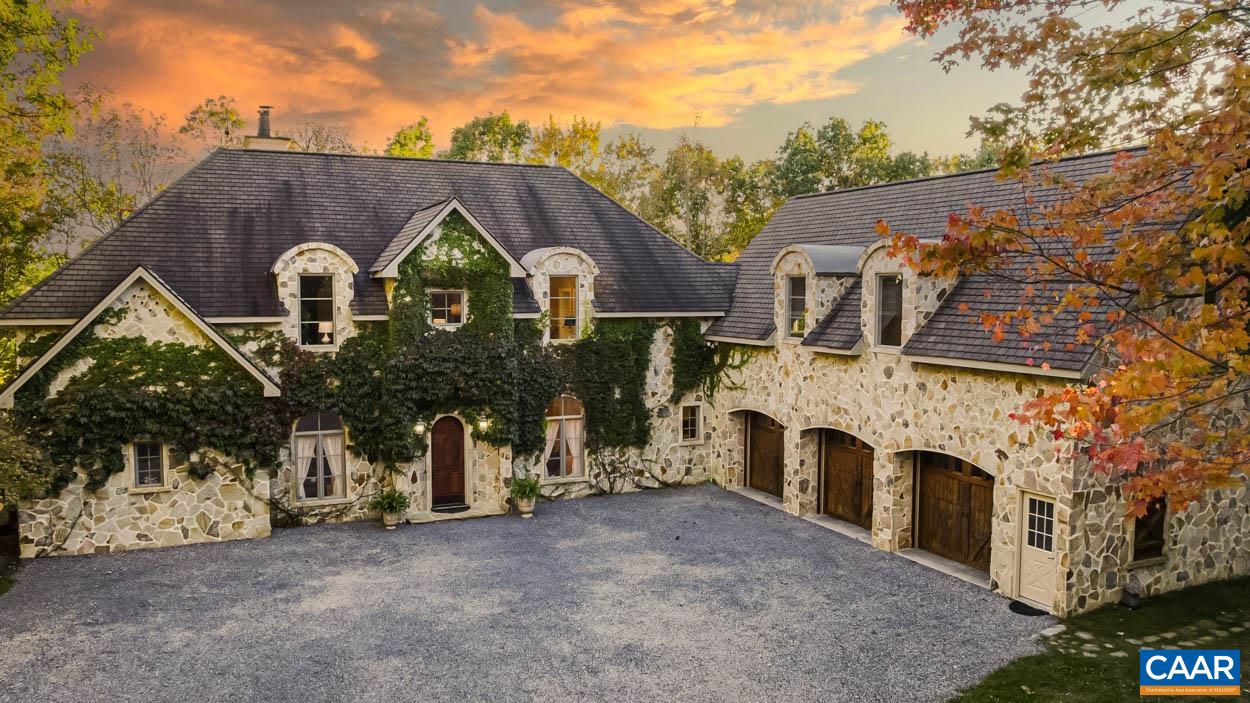 a aerial view of a house with a yard and garage