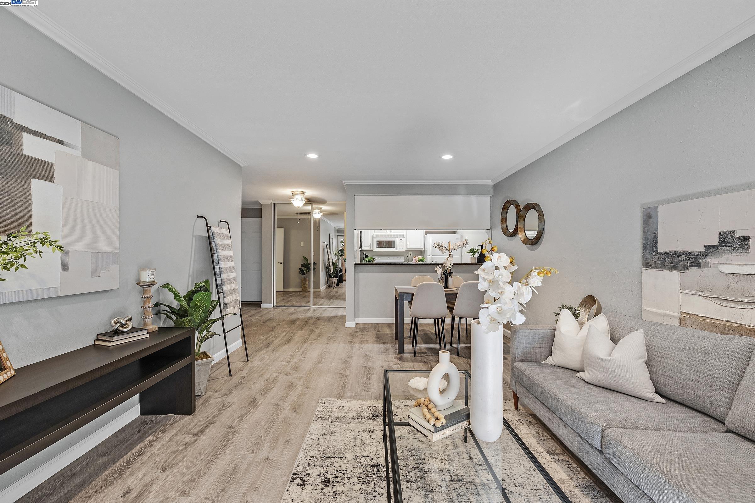 a living room with furniture and a kitchen view