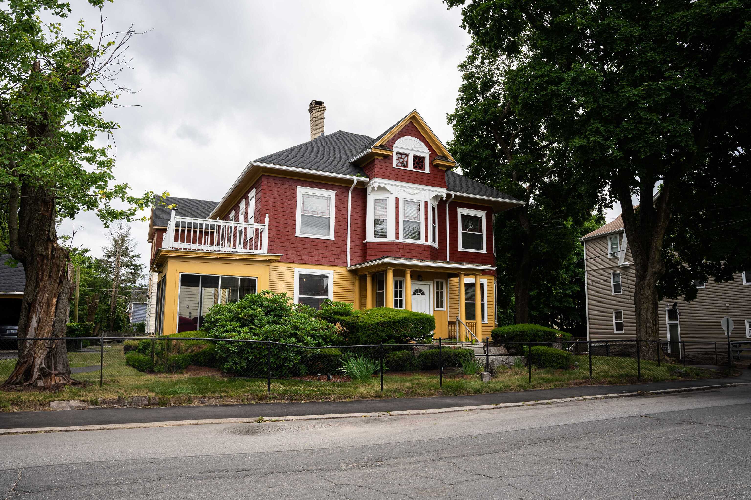 a front view of a house with a yard and trees