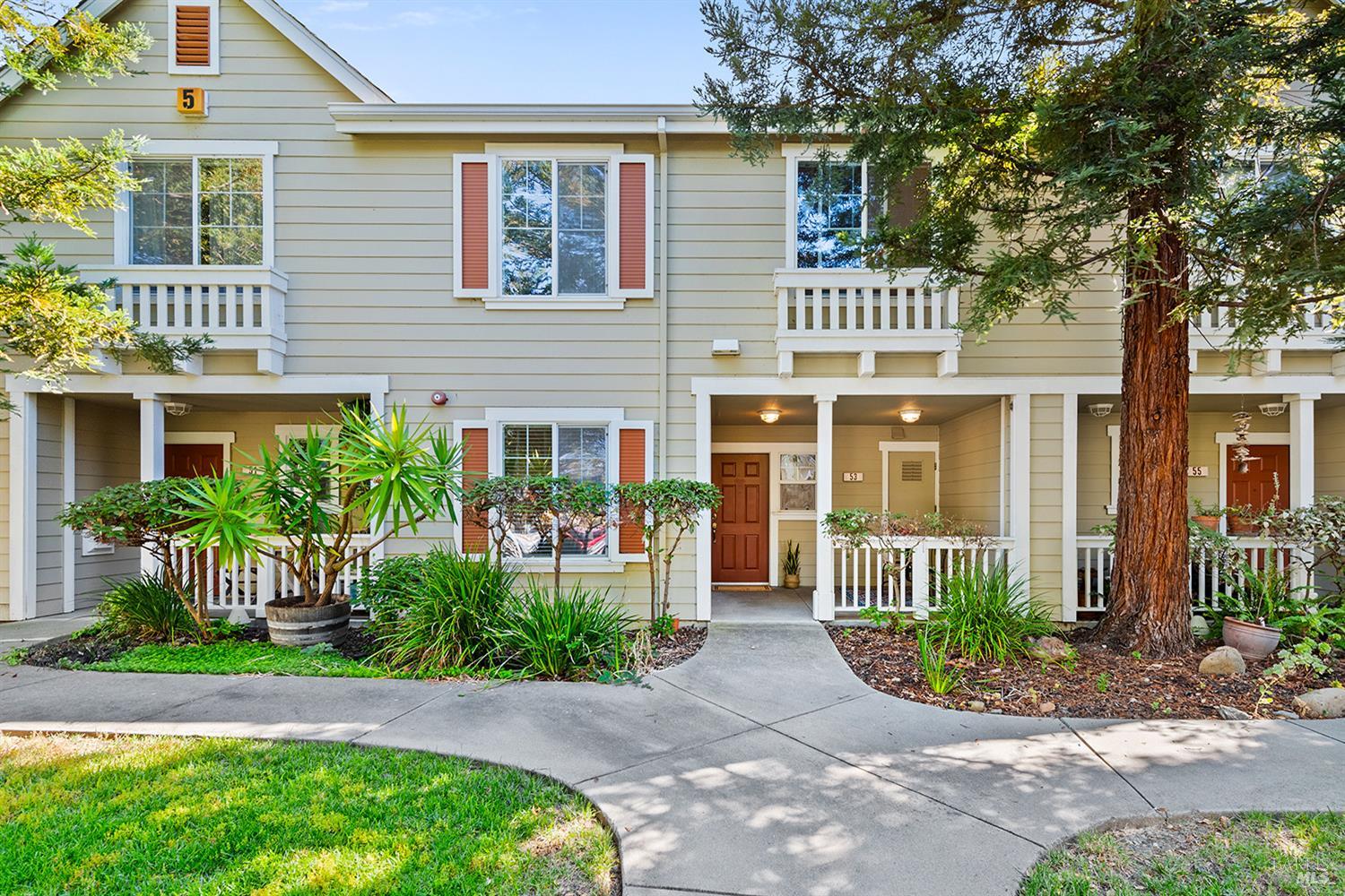 a front view of a house with garden