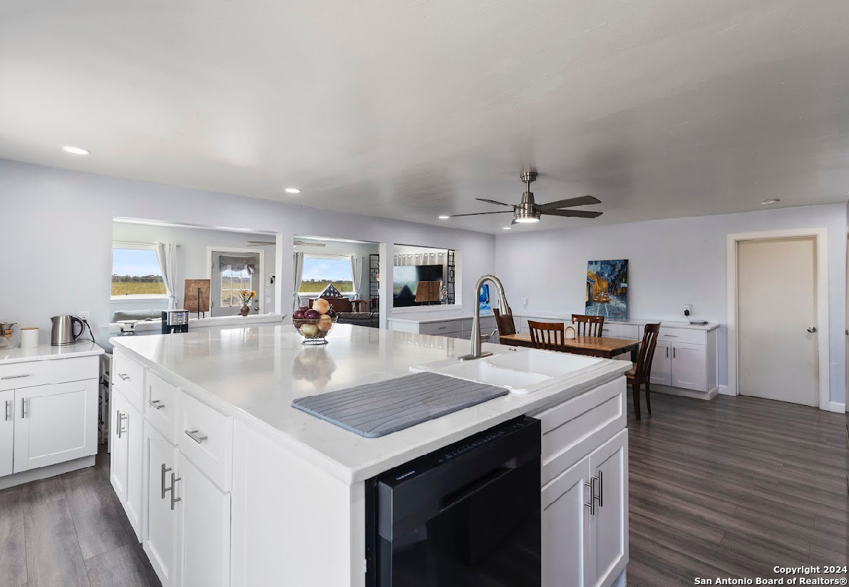 a view of kitchen island a sink and living room