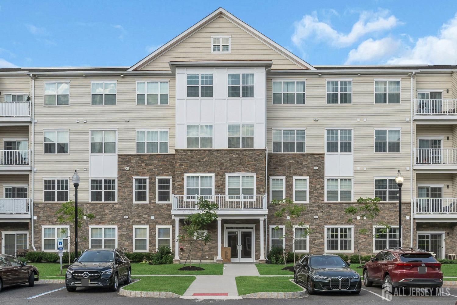 a front view of a residential apartment building with a yard