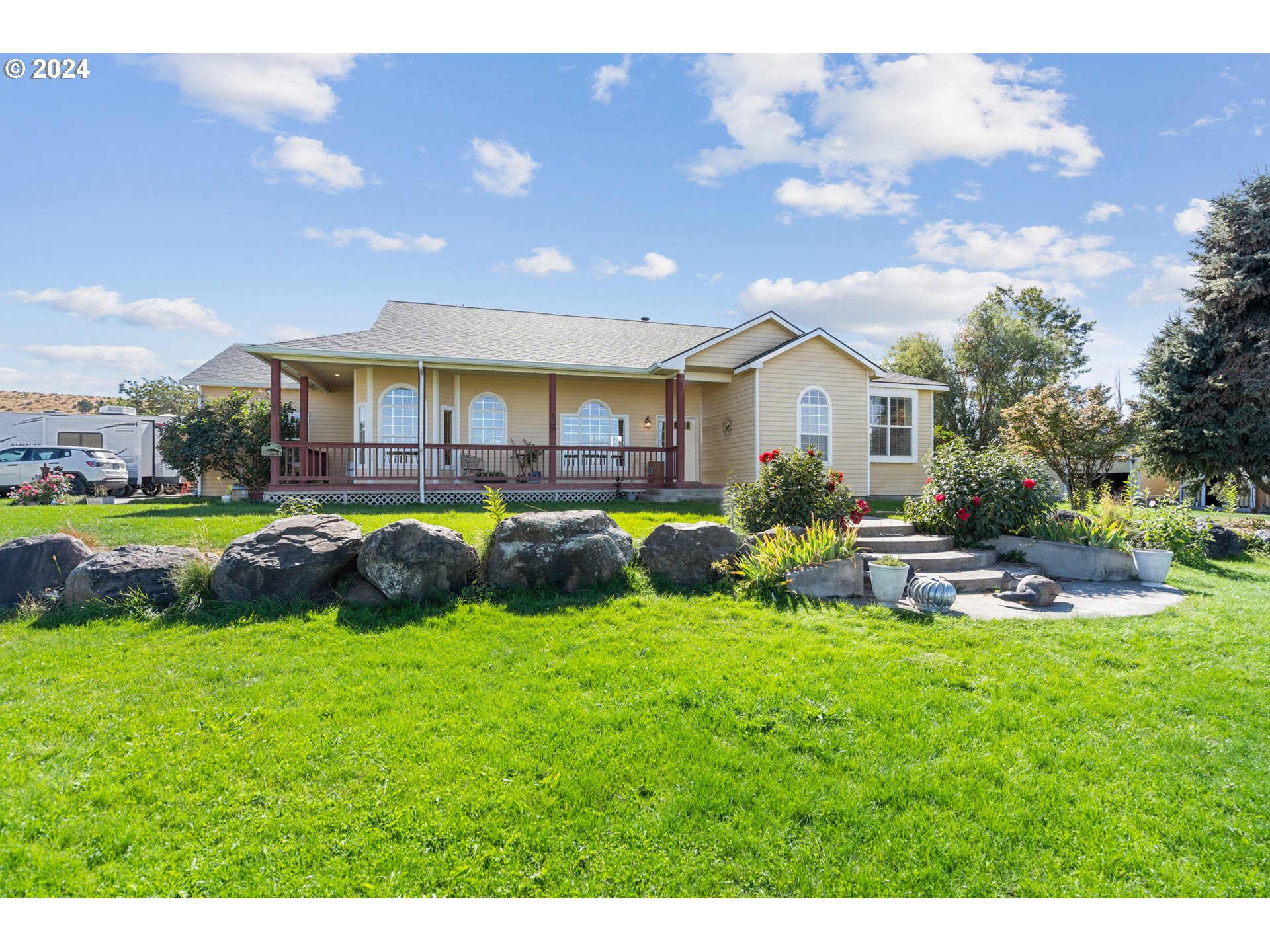 a view of a house with a yard porch and sitting area