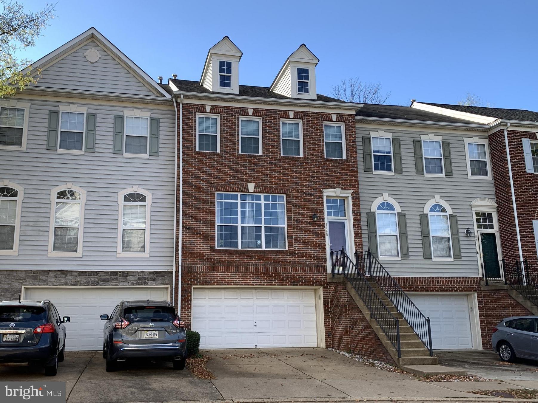 a front view of a house with parking space