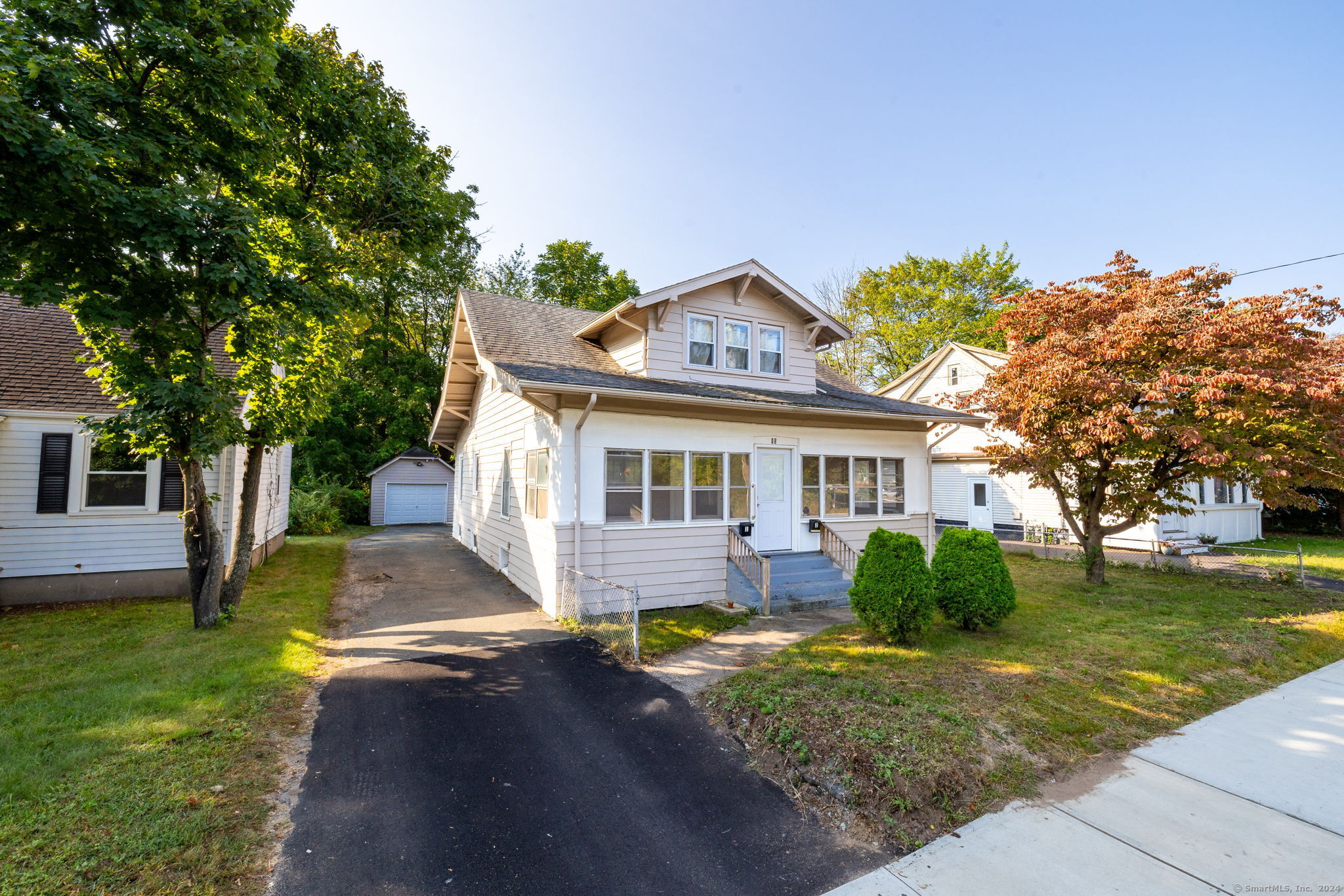 a front view of house with yard and green space