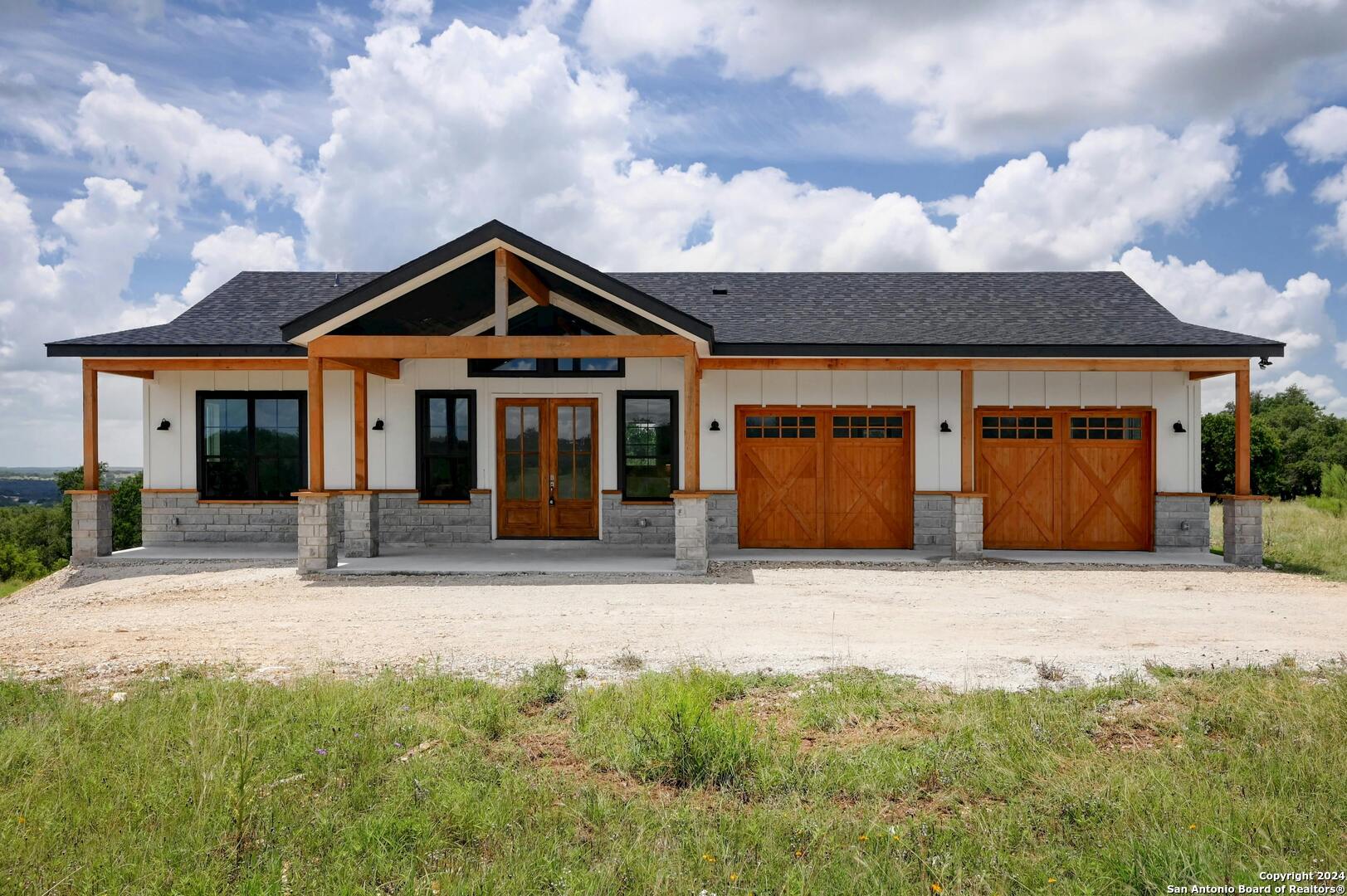 a front view of a house with yard and garage