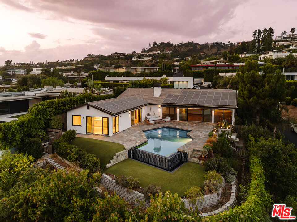 an aerial view of a house with a big yard