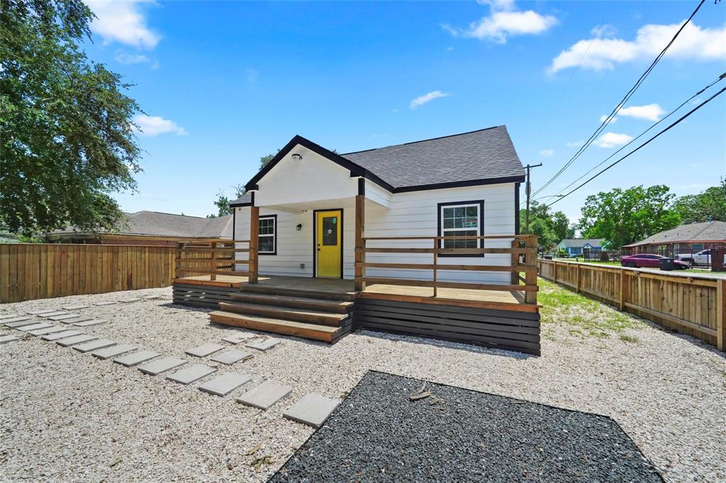 a front view of a house with wooden fence