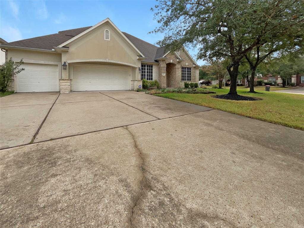 a front view of a house with a yard and trees