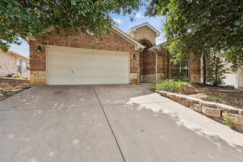 a view of a house with a yard and garage