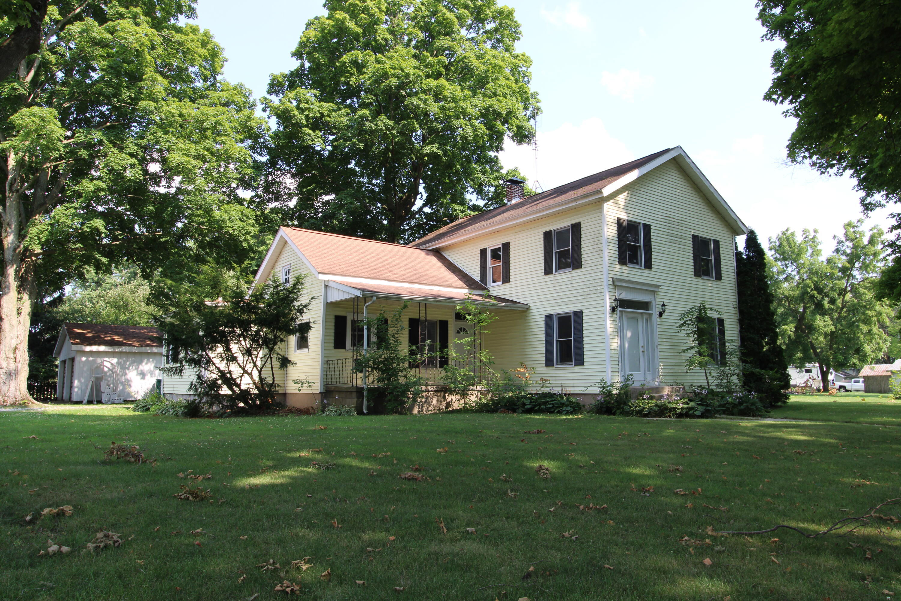 a front view of house with yard and green space