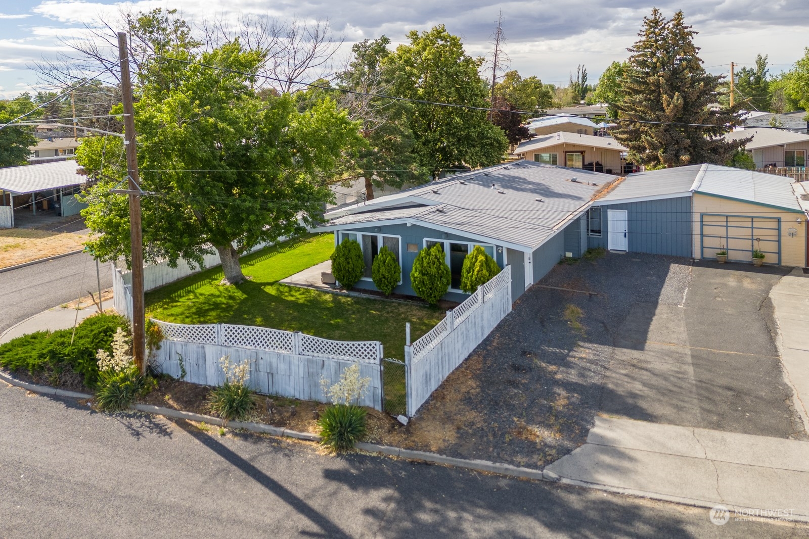 a view of a wooden fence and a yard