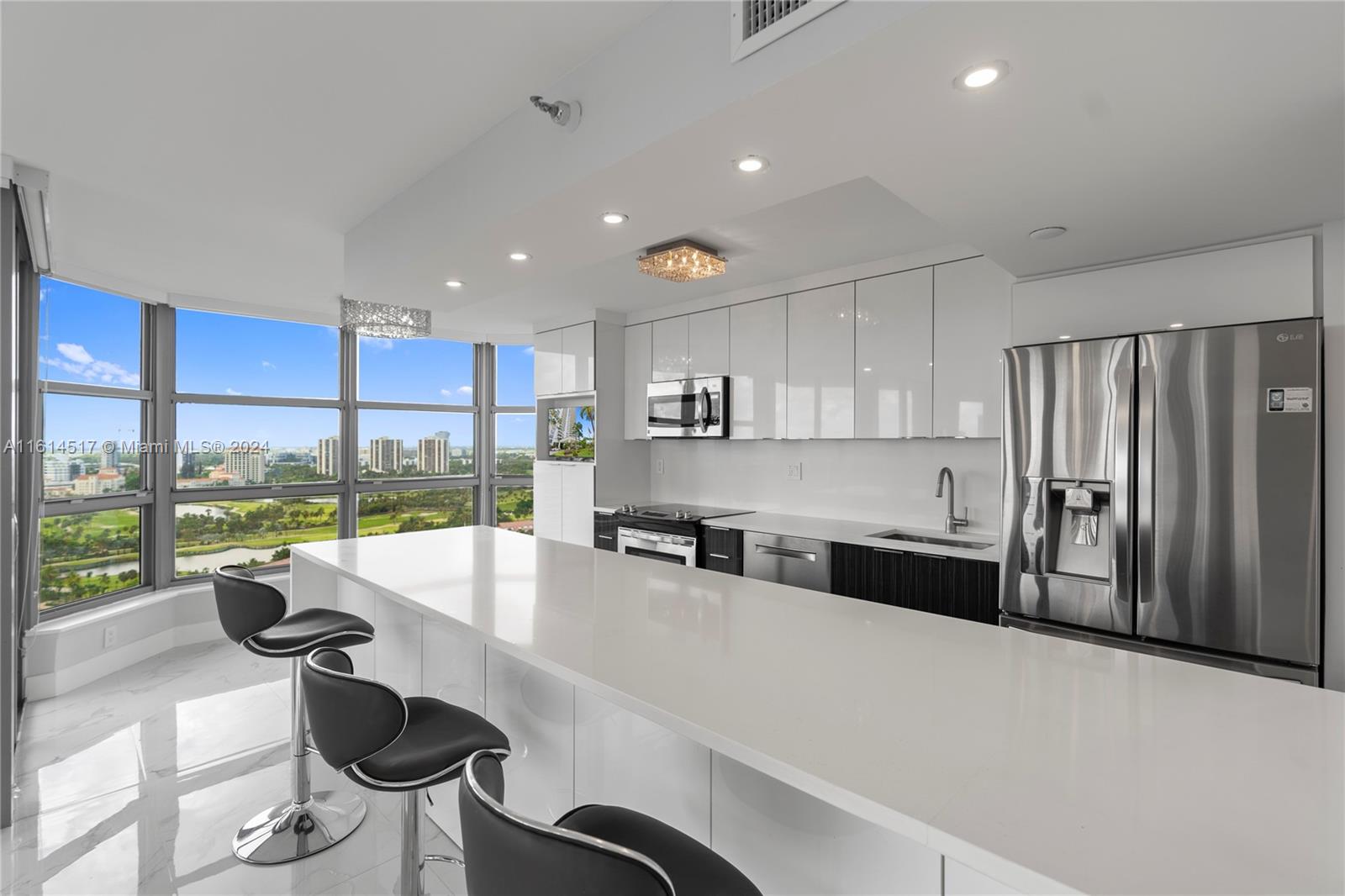 a kitchen with stainless steel appliances granite countertop a sink and a refrigerator