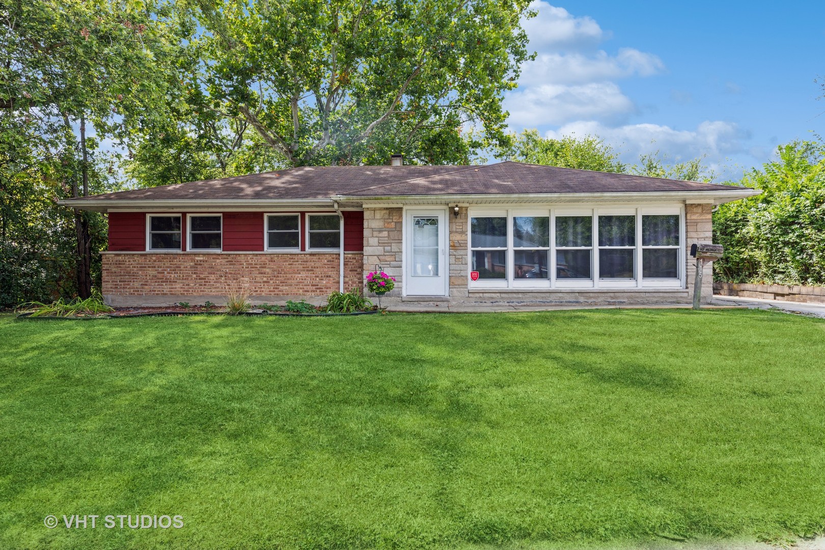 a front view of house with yard and green space