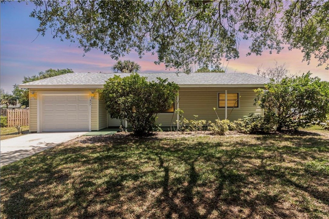 front view of a house with a tree