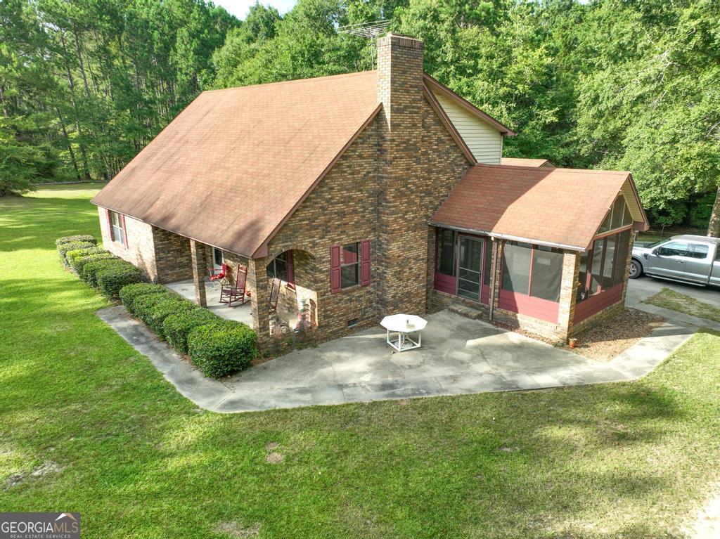 a aerial view of a house with yard and green space