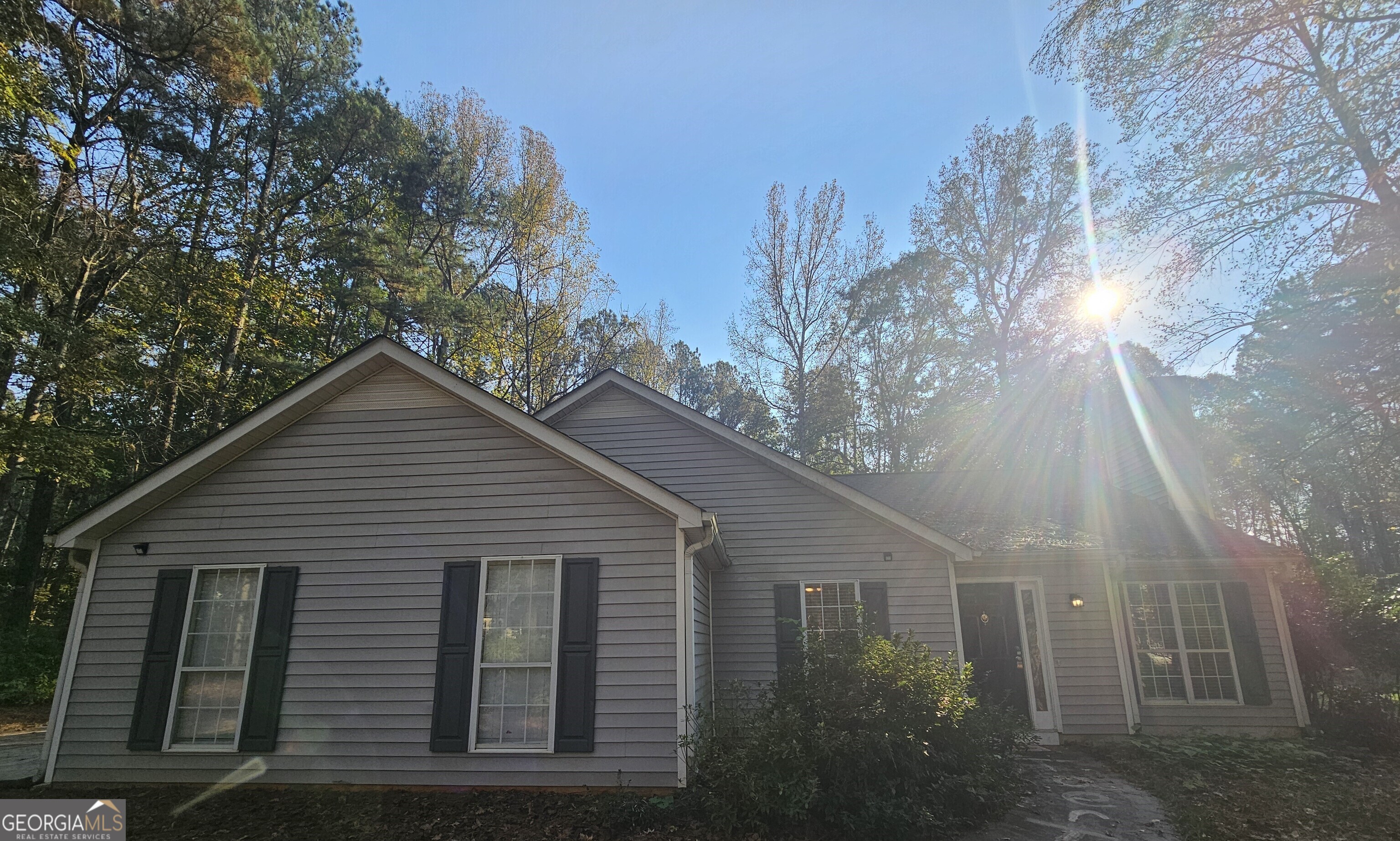 a view of a house with a yard and tree s