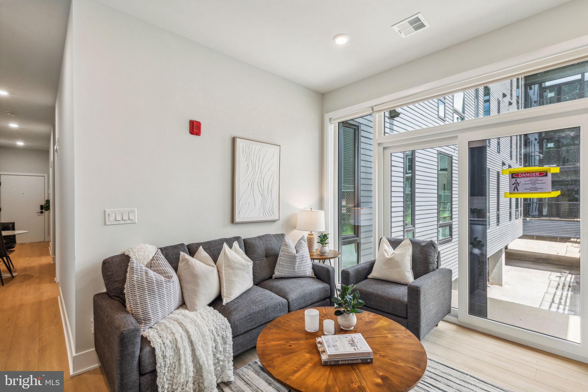 a living room with furniture and a large window