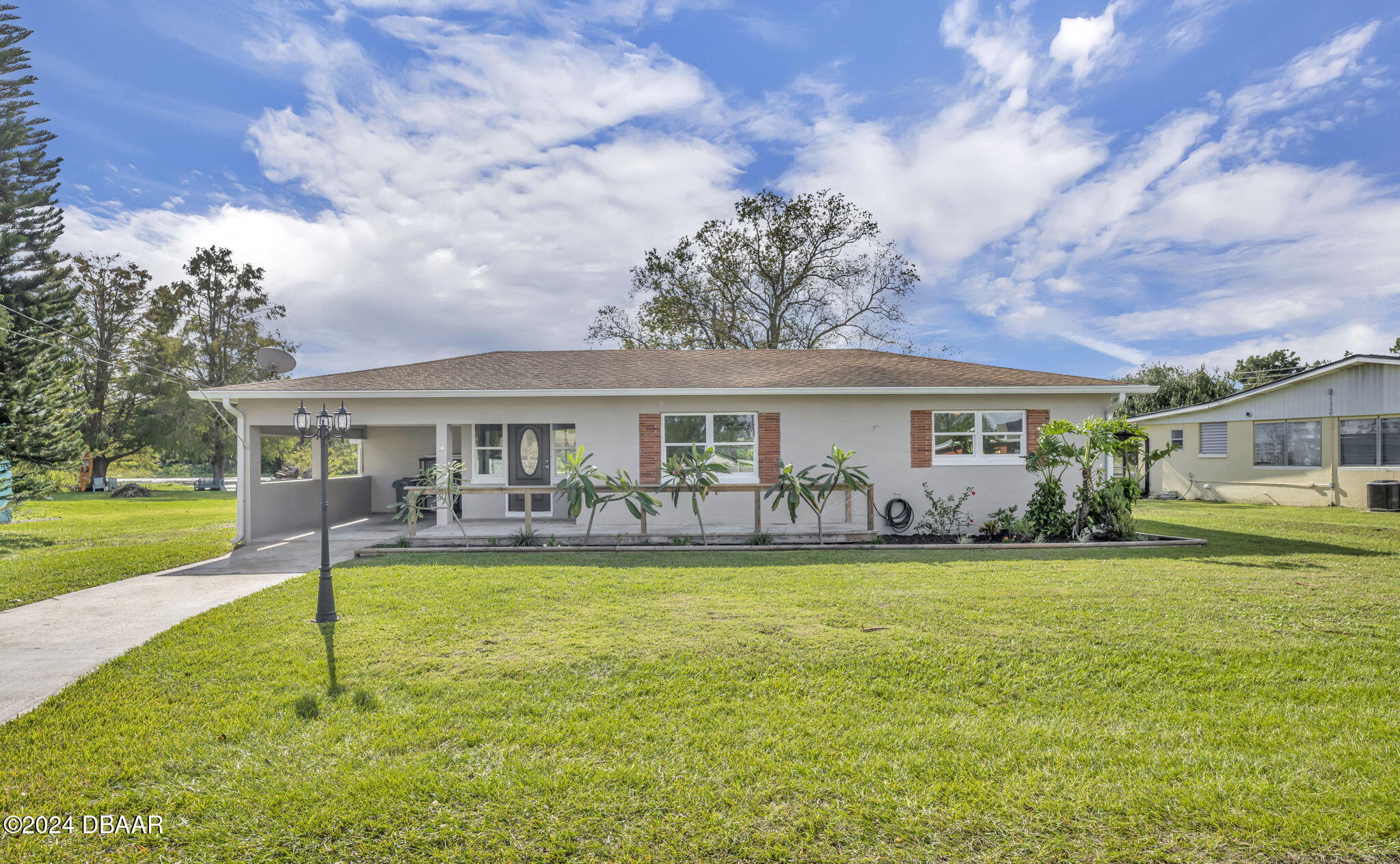 a front view of a house with garden