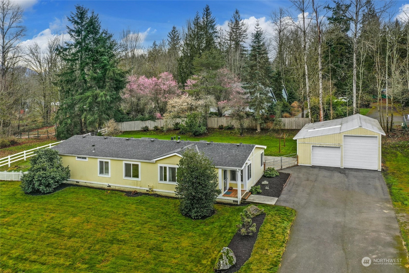 a aerial view of a house with swimming pool next to a big yard