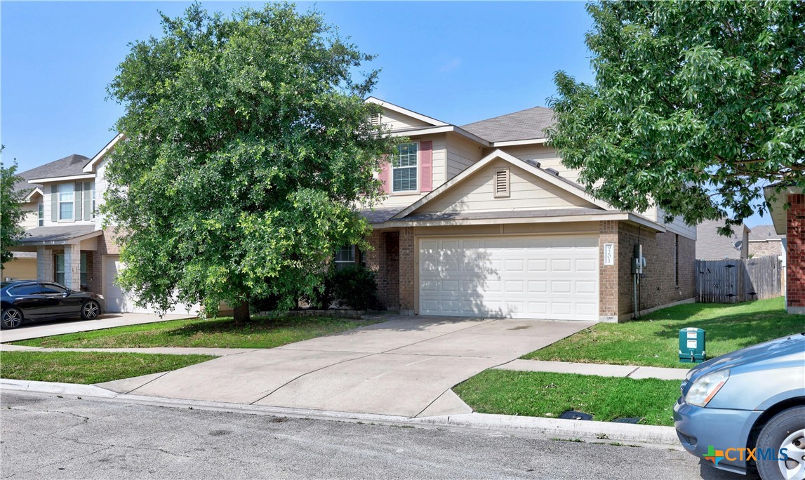 a front view of a house with a yard and garage