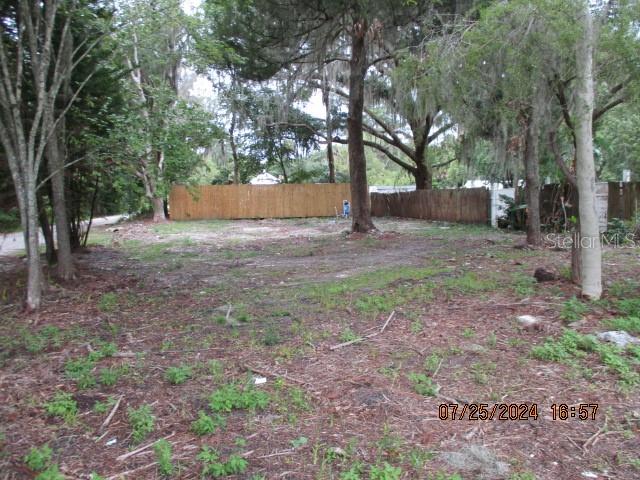 a view of a yard with tree s