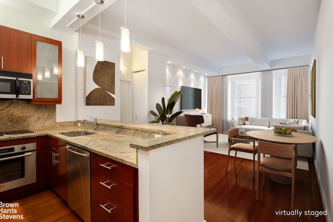 a kitchen with a table chairs sink and cabinets