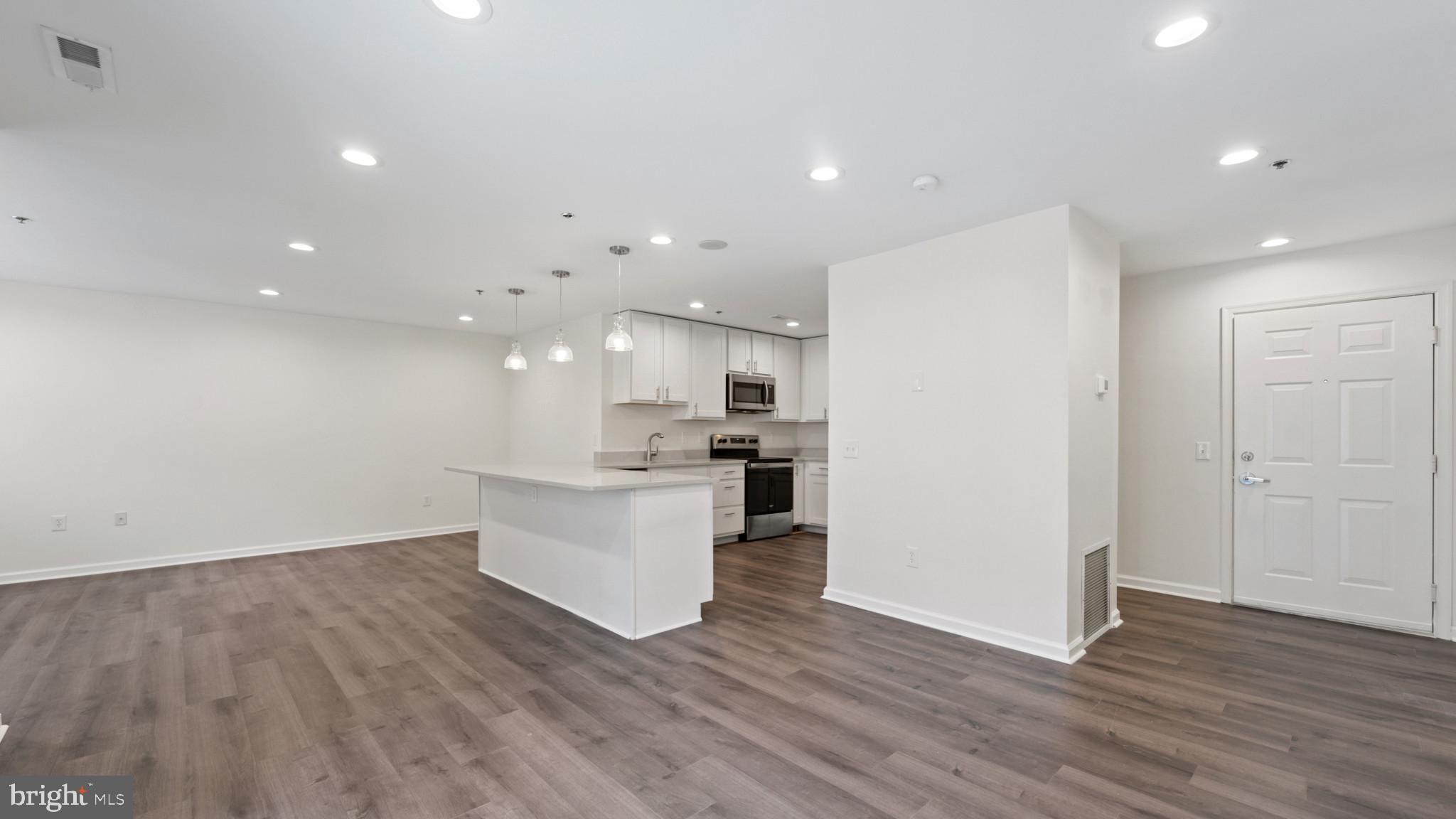 a view of kitchen with wooden floor