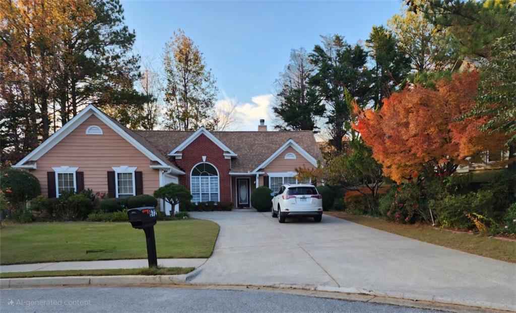 a front view of a house with a garden and trees