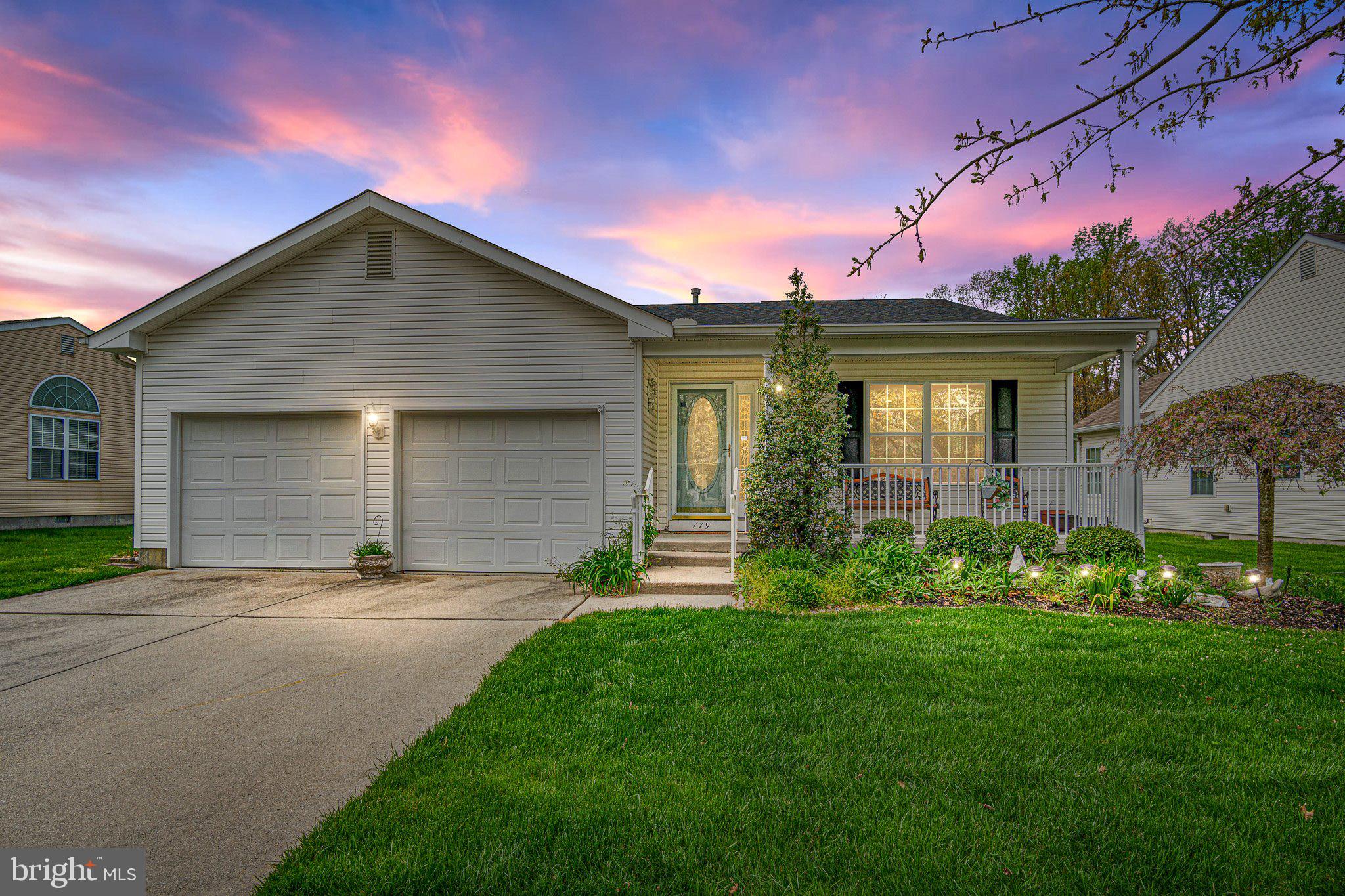 a front view of house with yard and green space