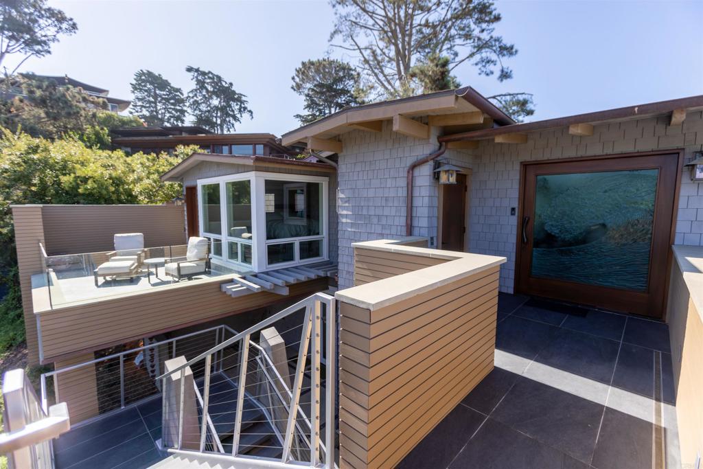 a view of a patio on the deck in front of house