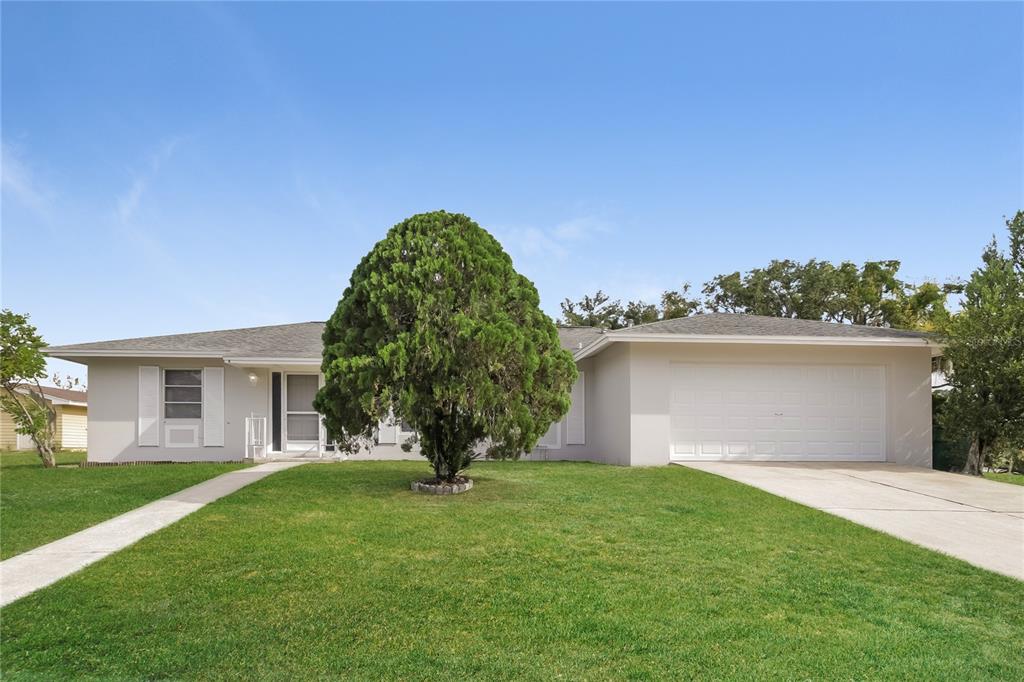 a view of a house with a yard