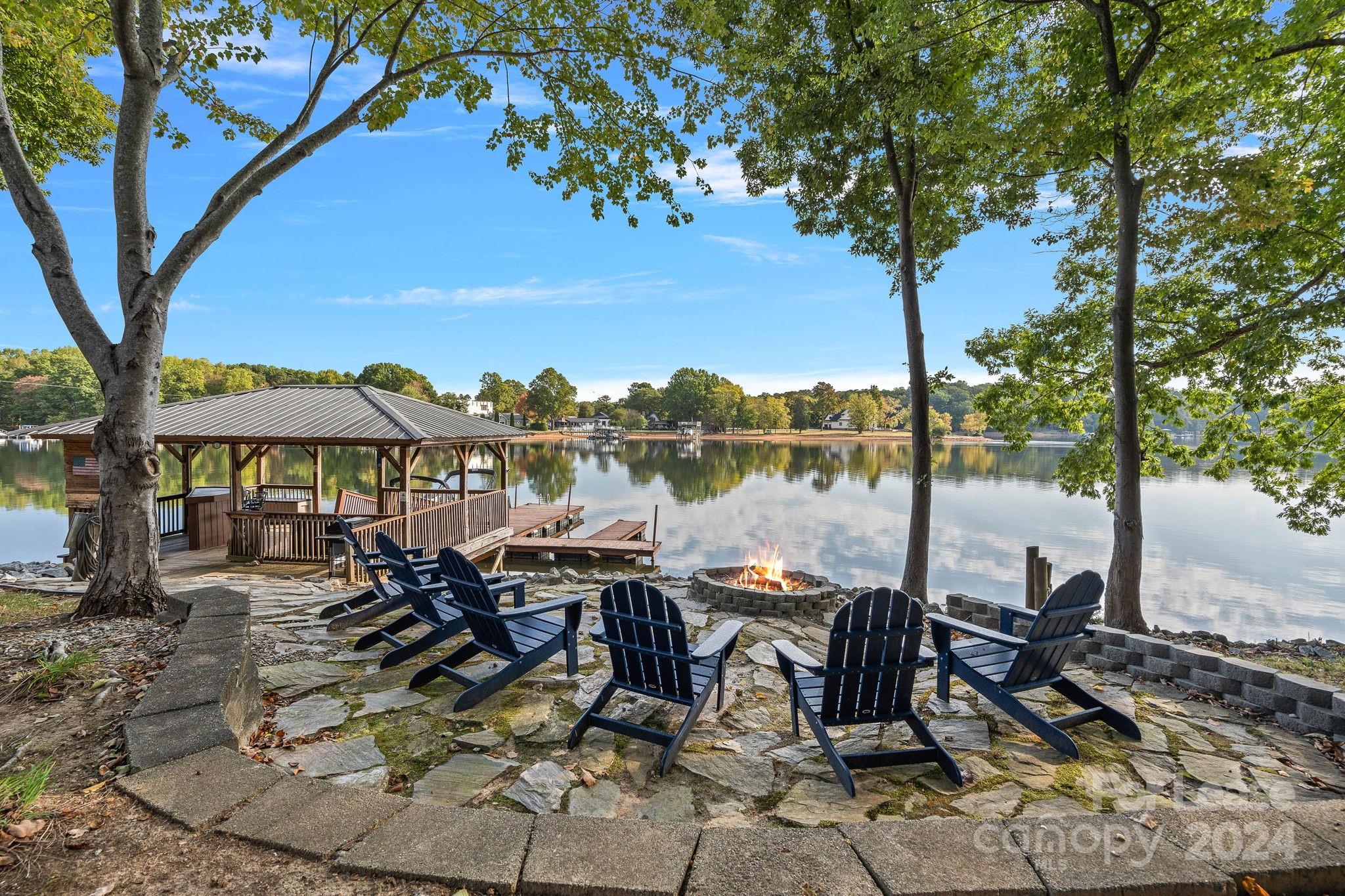 a view of a patio with table and chairs under an umbrella