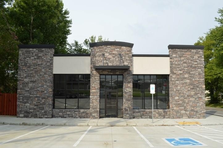 a brick building with a door in front of it