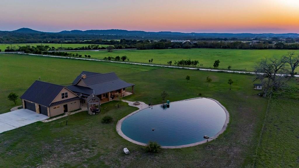 an aerial view of a house with outdoor space and pool