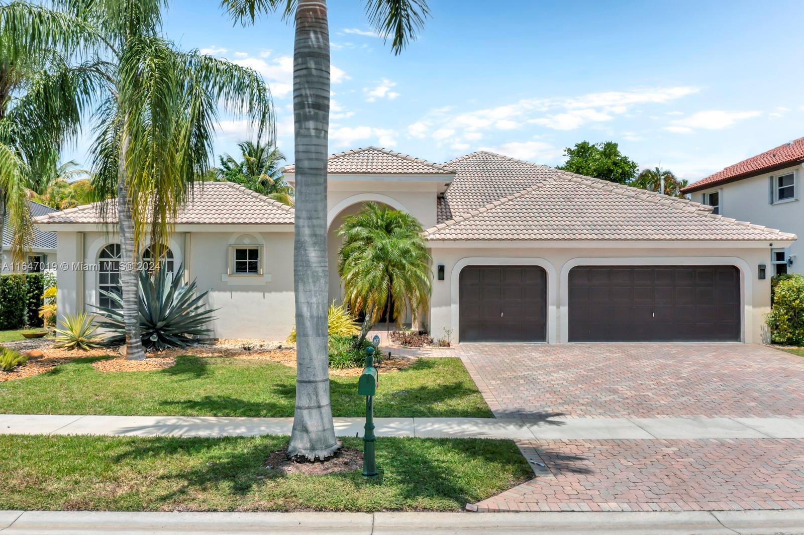 a front view of a house with a garden and patio