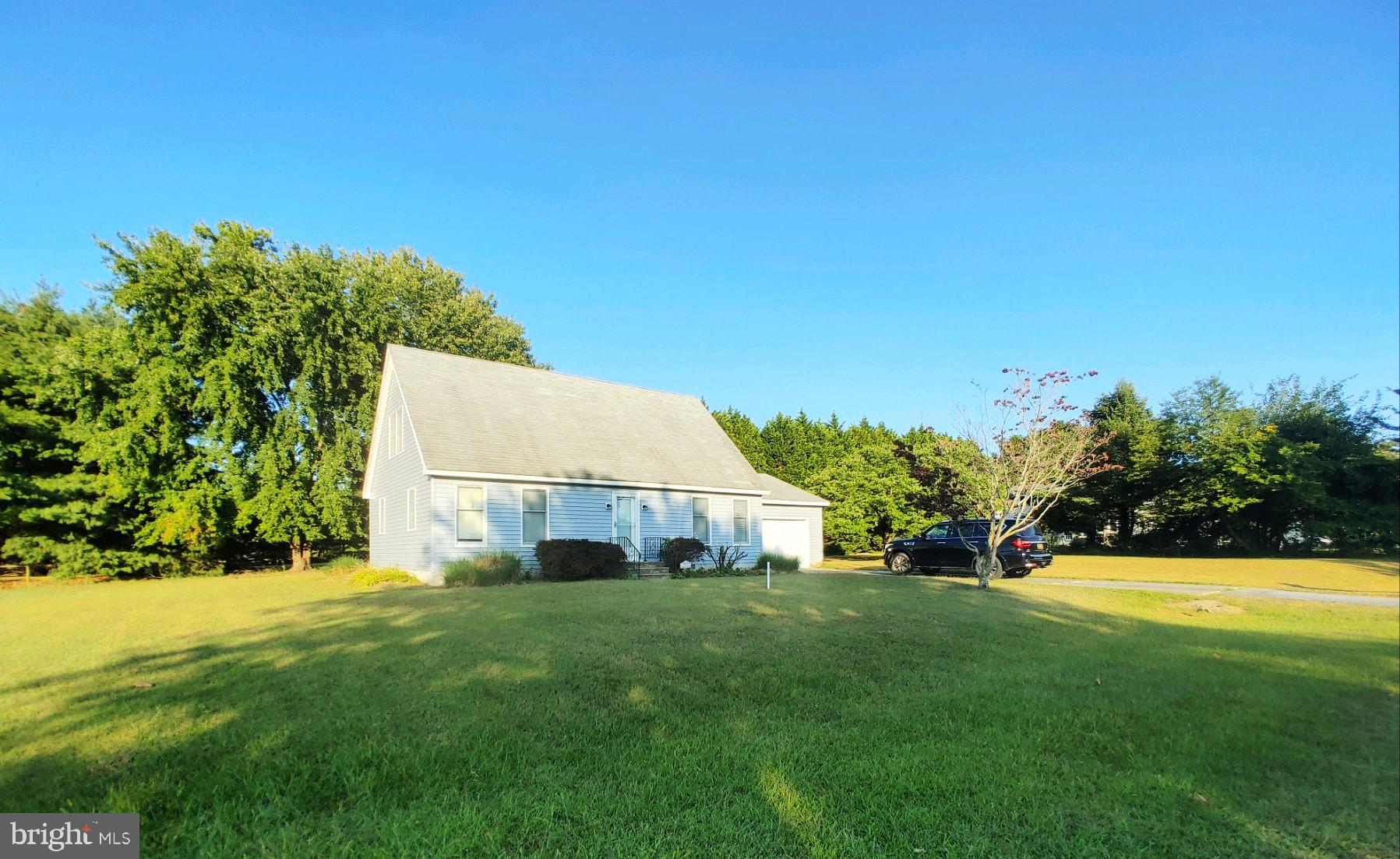 a view of an house with backyard space and garden