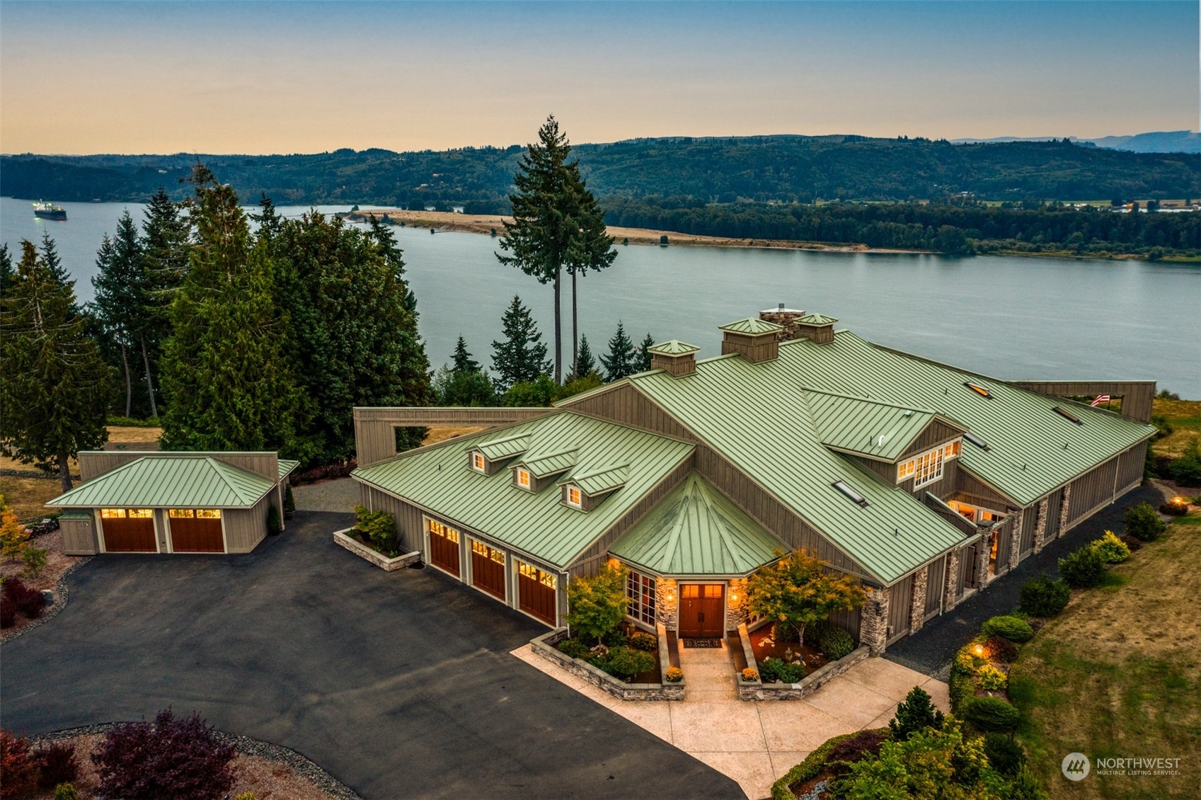 an aerial view of a house with pool and lake view