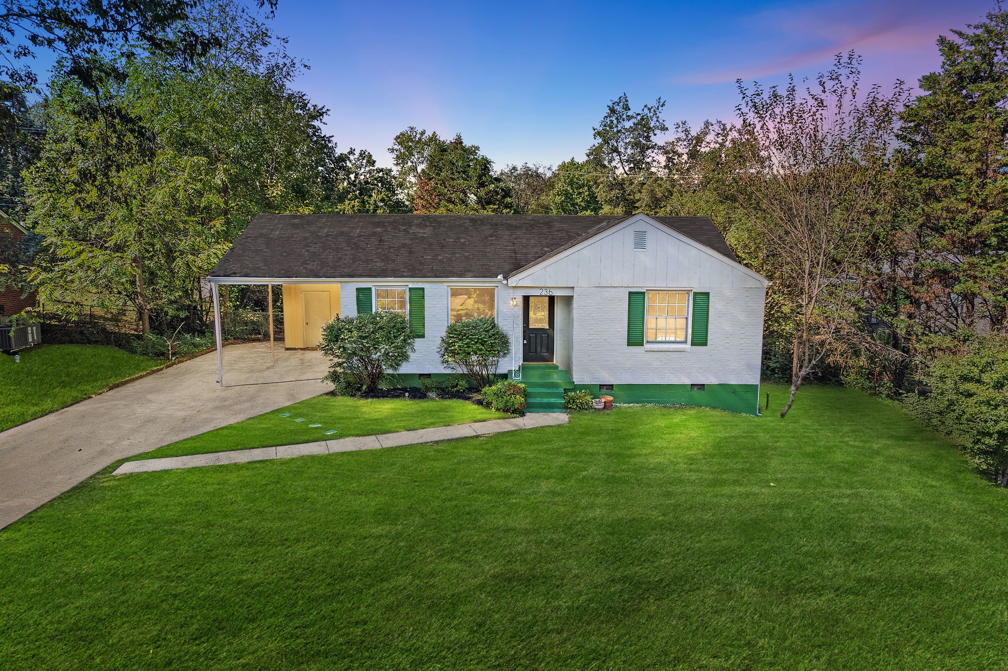 a front view of a house with a garden