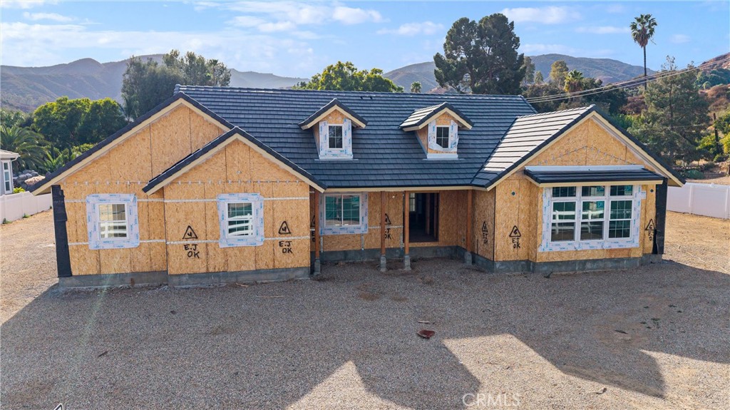 a view of a house with a yard and roof deck