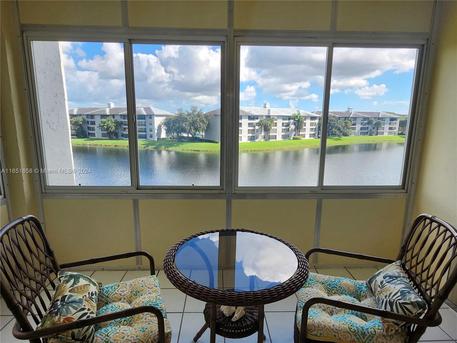 a view of a chairs and table in a balcony