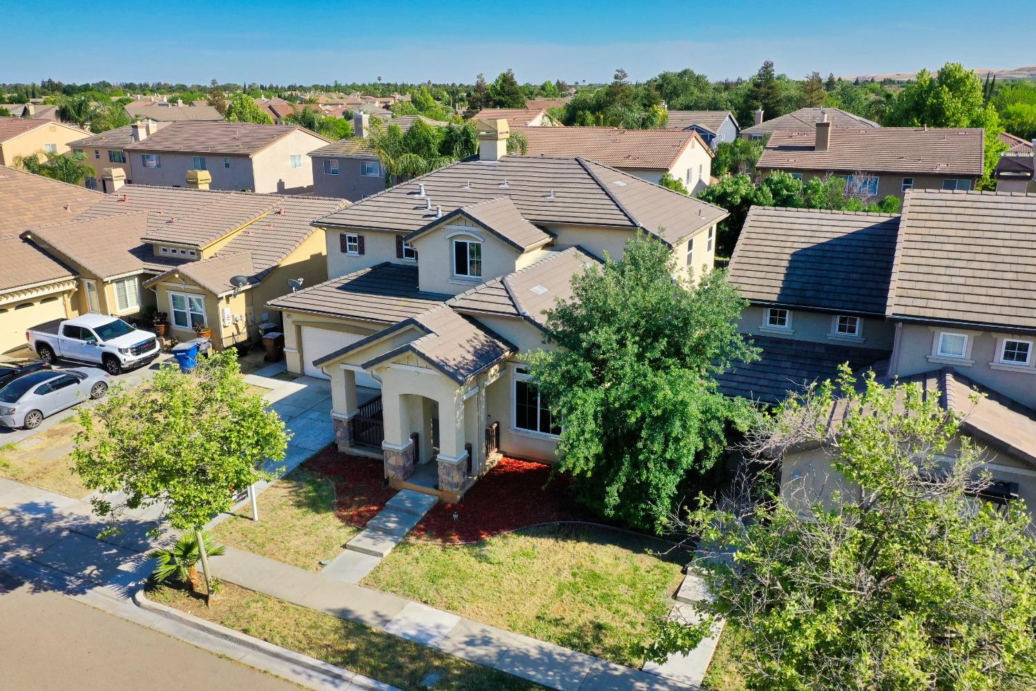 an aerial view of residential houses with yard