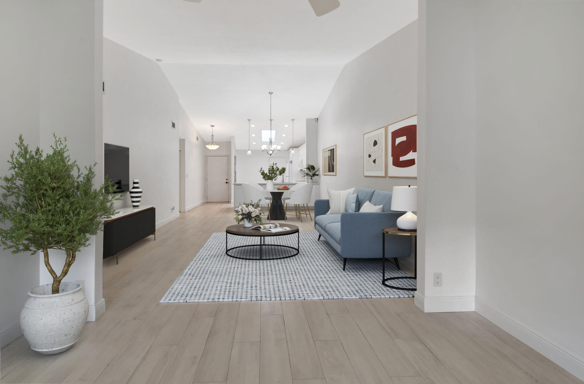 a living room with furniture and a potted plant