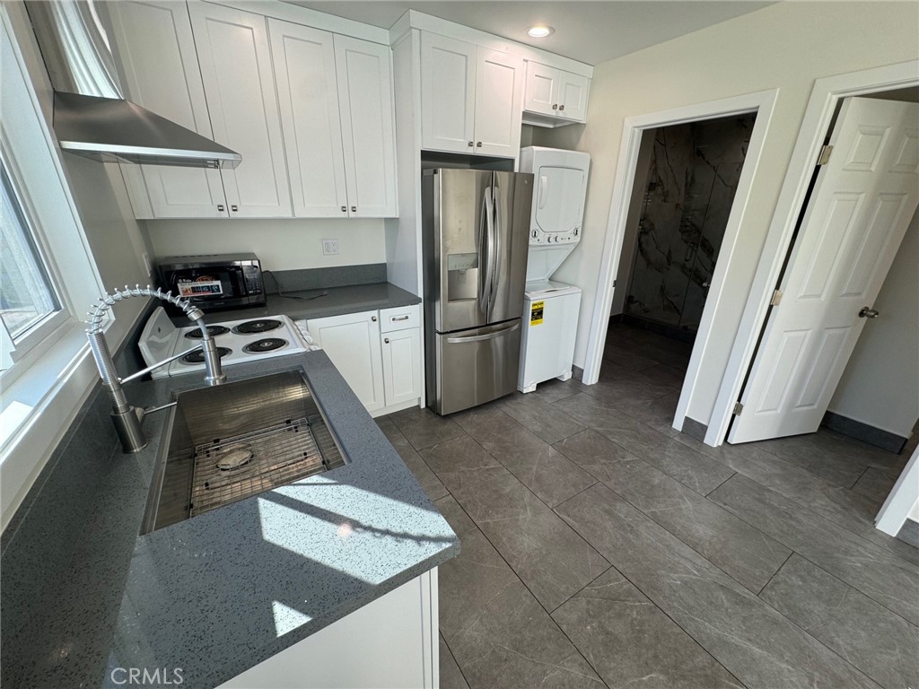 a kitchen with a refrigerator sink and stove