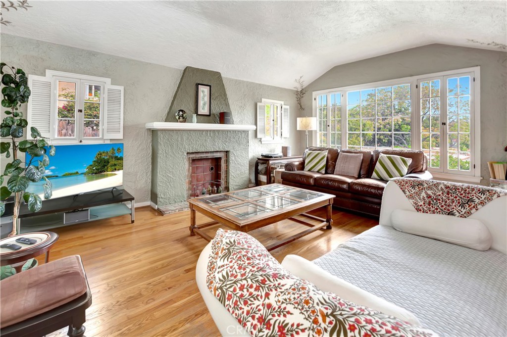 a living room with furniture large window and a fireplace