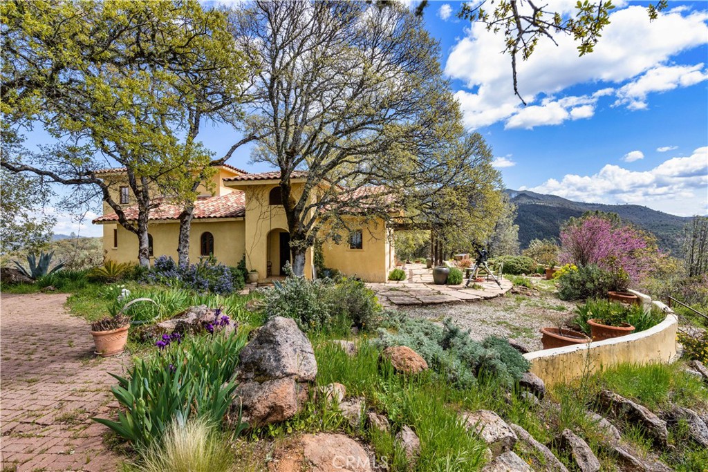 a front view of a house with a yard and fountain