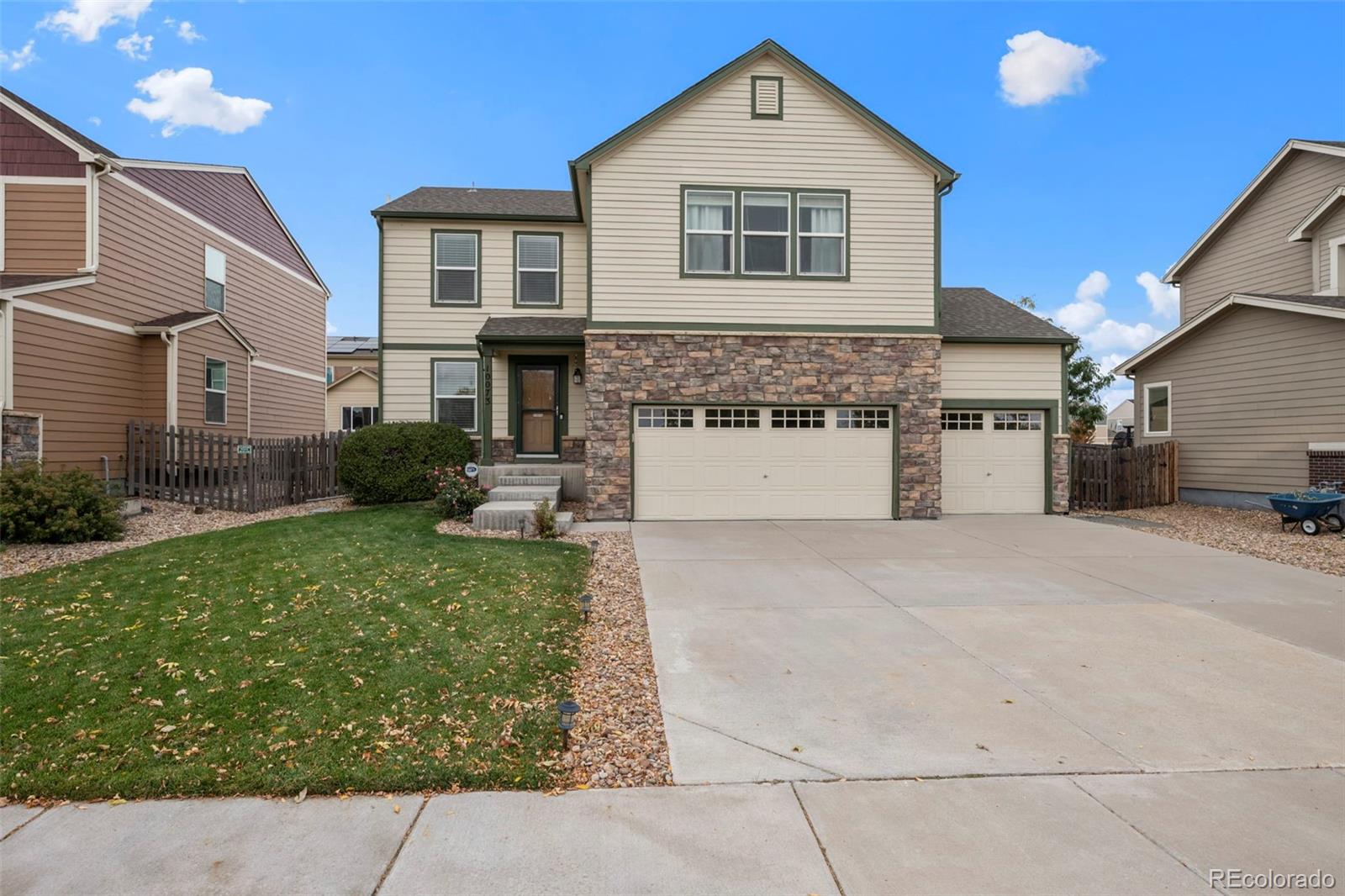 a front view of a house with a yard and garage