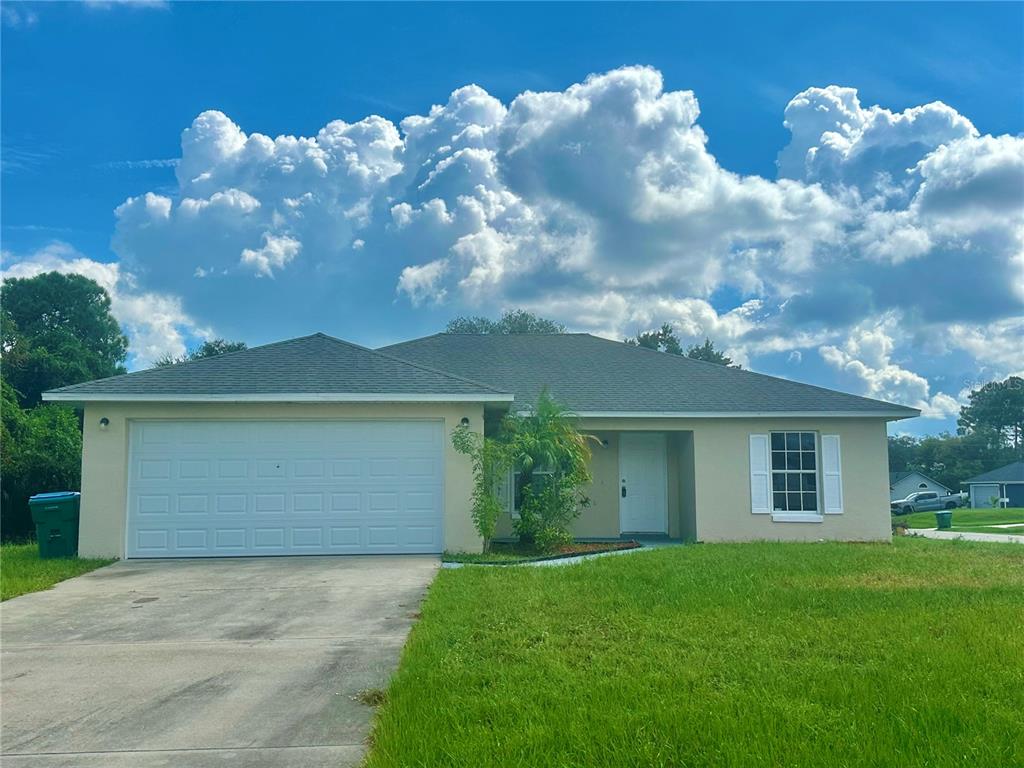 a front view of house with yard and green space