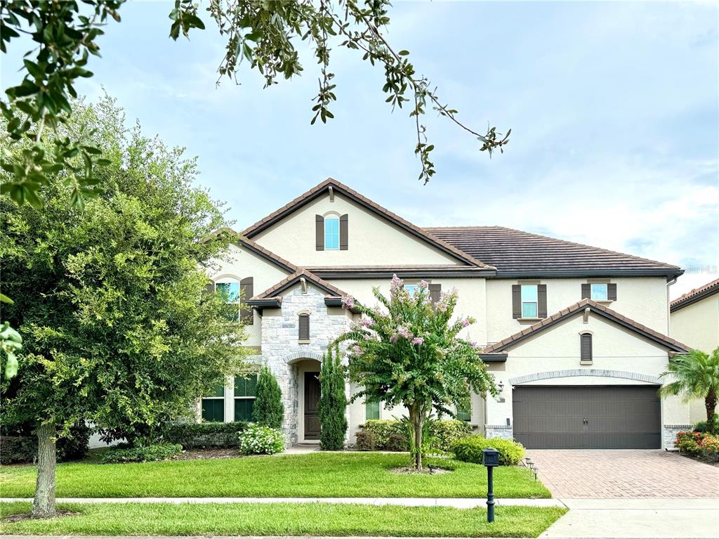 a front view of a house with a yard and garage